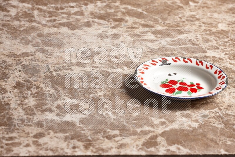 A vintage metal plate on beige marble background
