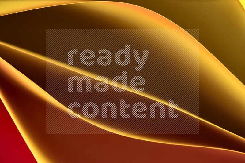 هذه الصورة تعرض تكوين فن الورق التجريدي مع منحنيات ورقية بتدرجات اللون الأصفر والأحمر والبني المكونه بواسطة الضوء الملون