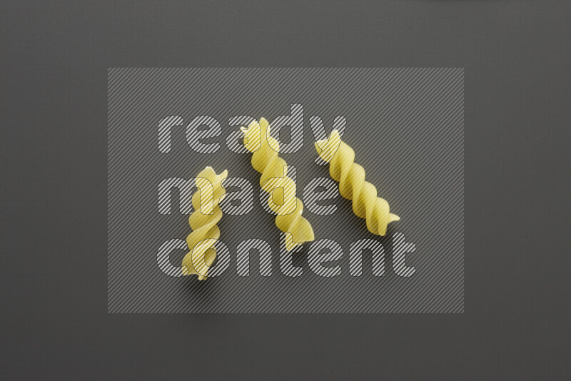 Fusilli pasta on grey background