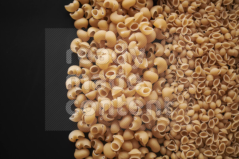 Different pasta types on black background