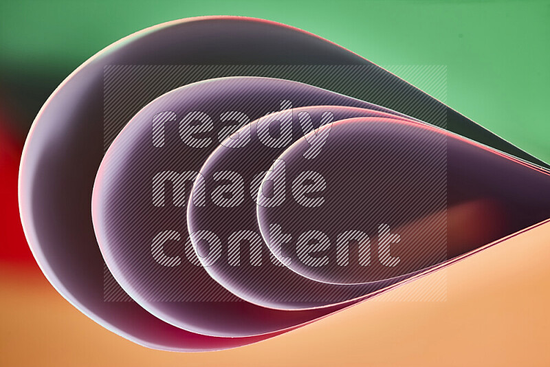 An abstract art of paper folded into smooth curves in green and red gradients