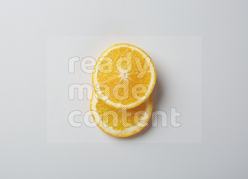 Two orange slices on white background