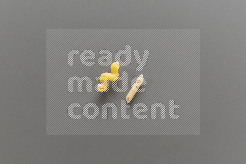 Twist pasta with other types of pasta on grey background