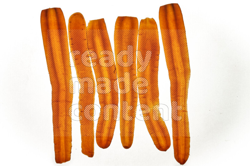 Carrots slices on illuminated white background