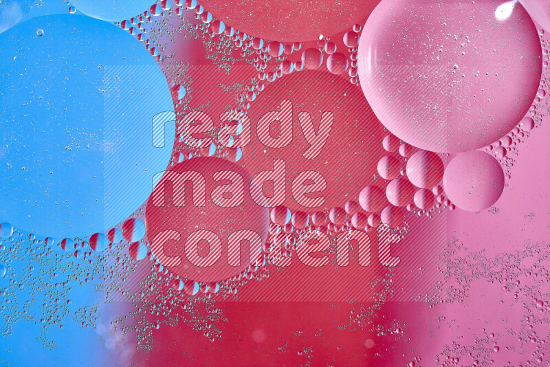 Close-ups of abstract oil bubbles on water surface in shades of blue, red and pink
