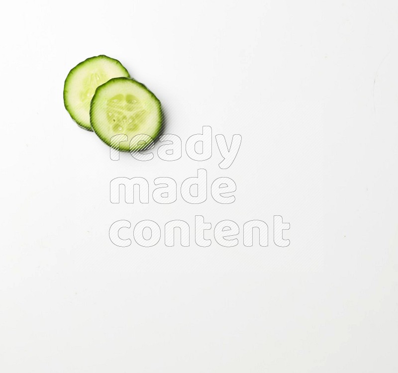 two cucumber slices on white background