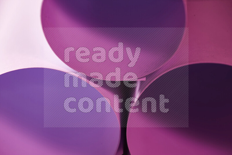 The image shows an abstract paper art with circular shapes in varying shades of pink