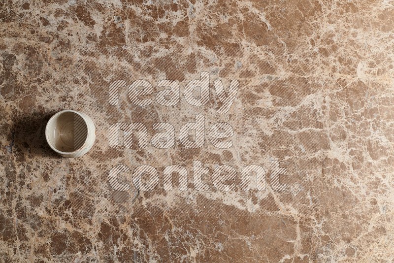 Top View Shot Of A Multicolored Pottery bowl On beige Marble Flooring