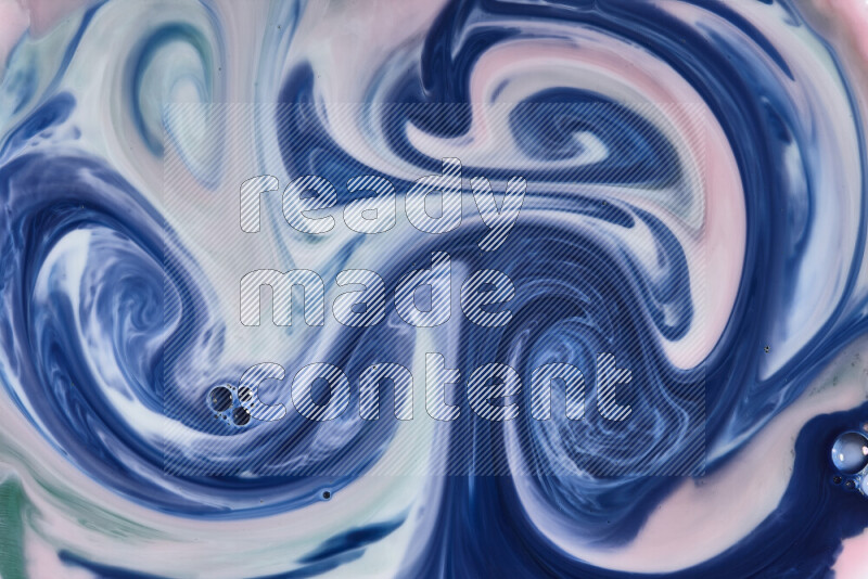 A close-up of abstract swirling patterns in red, green, white and blue