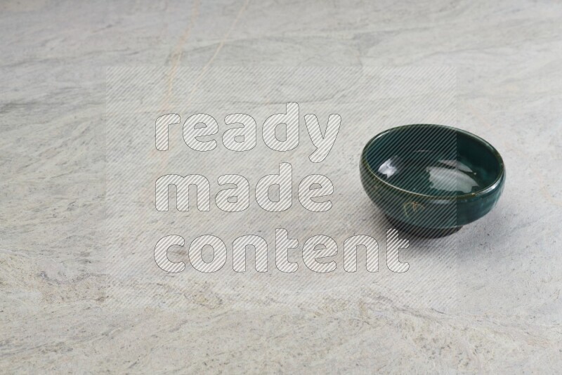 A multicolored pottery bowl on grey marble background