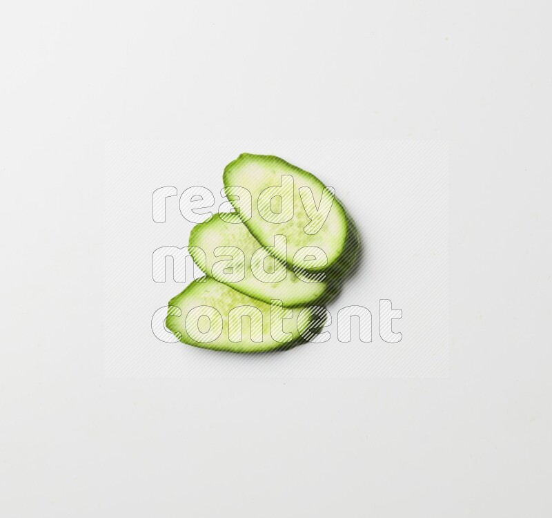 three cucumber slices on white background
