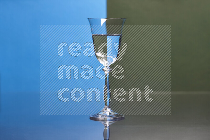 The image features a clear glassware filled with water, set against blue and dark green background