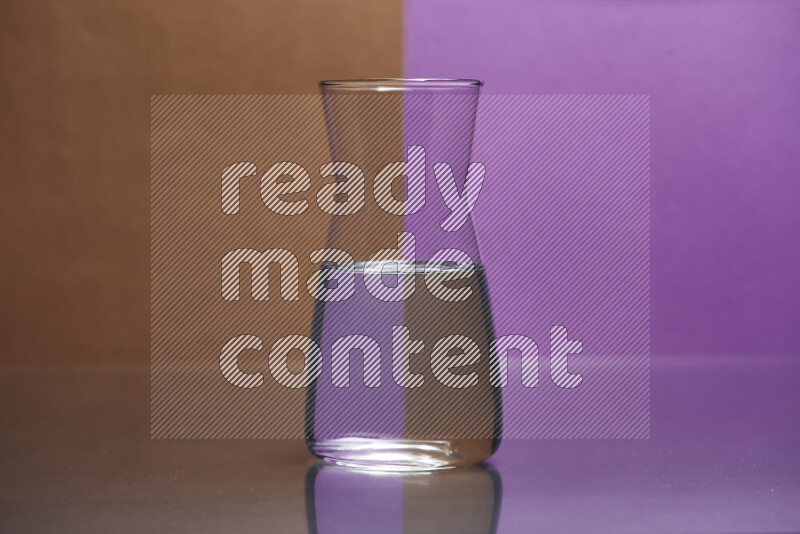 The image features a clear glassware filled with water, set against brown and purple background