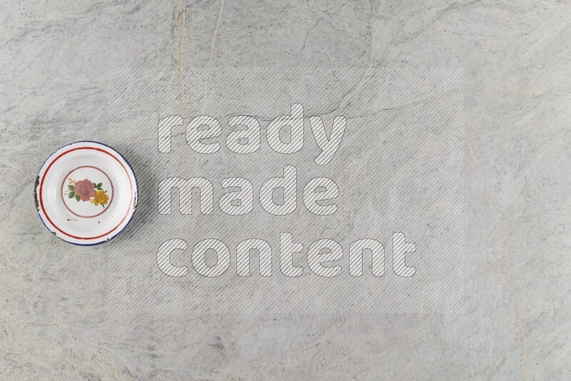 A vintage metal plate on grey marble background