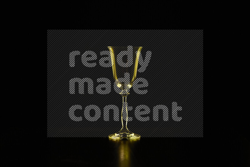 Glassware with rim light in yellow against black background