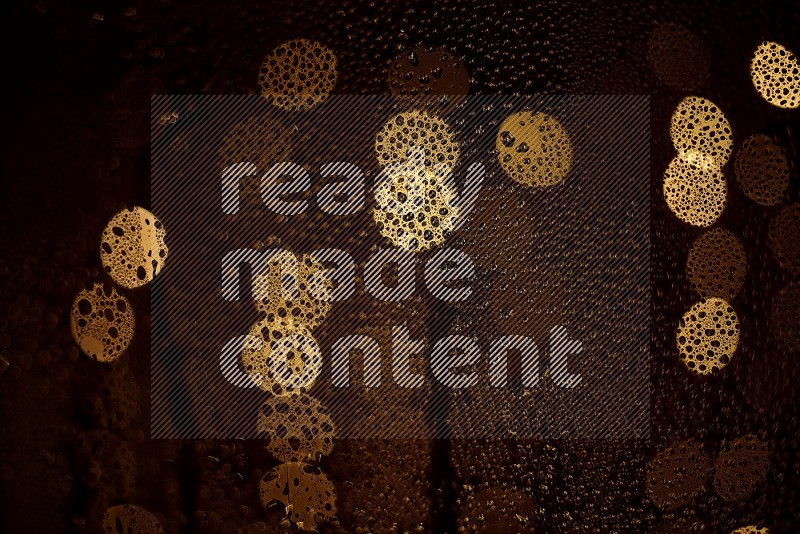 Bokeh light in yellow with water drops