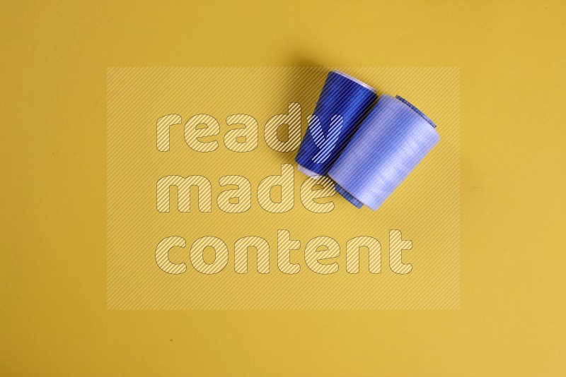 Blue sewing supplies on yellow background
