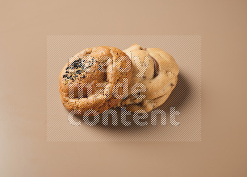 Two piece of mixed cookies on a brown background