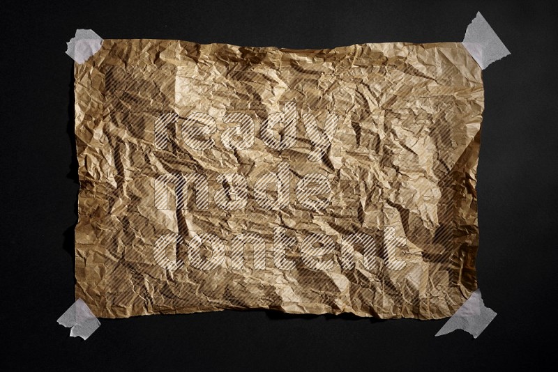 Crumpled craft paper on black background