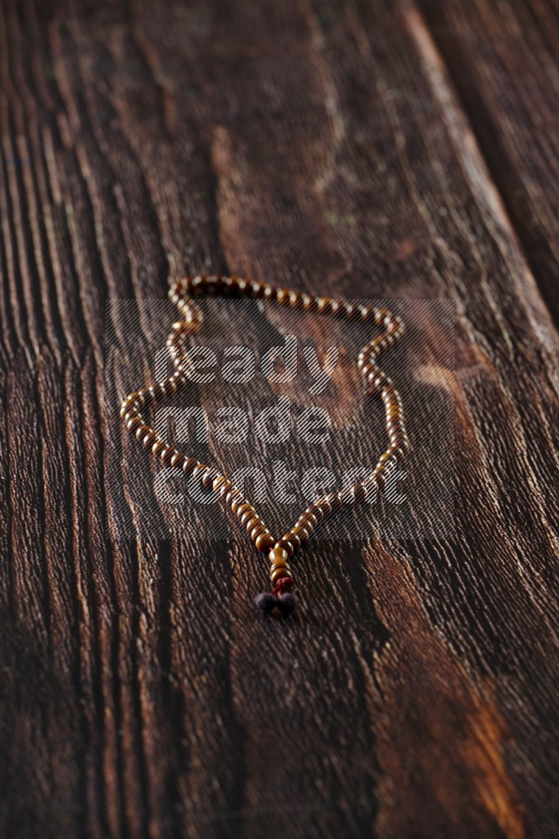 Prayer beads on wooden background