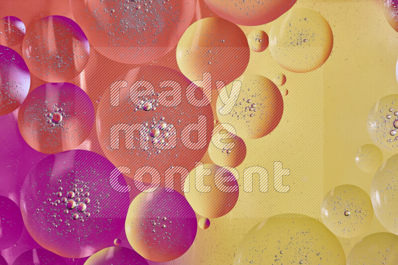 Close-ups of abstract oil bubbles on water surface in shades of yellow, orange and pink