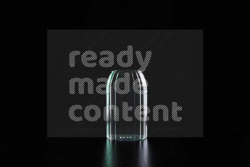 Glassware with rim light in green and white against black background