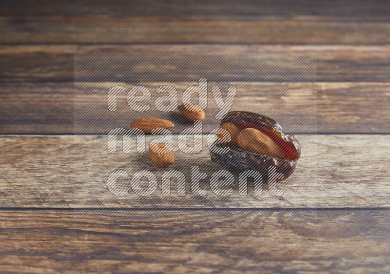 almond stuffed madjoul date on a wooden background