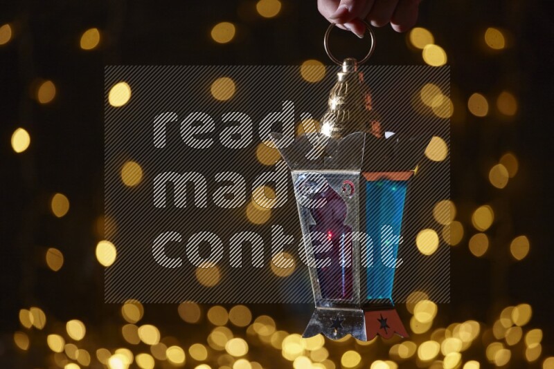 A traditional ramadan lantern surrounded by glowing fairy lights in a dark setup
