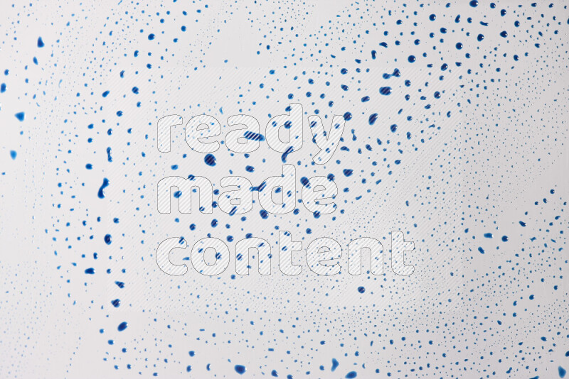 Close-ups of abstract blue paint droplets on the surface