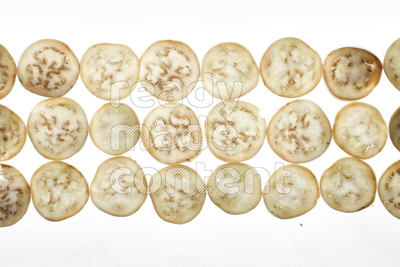 Eggplant slices on illuminated white background