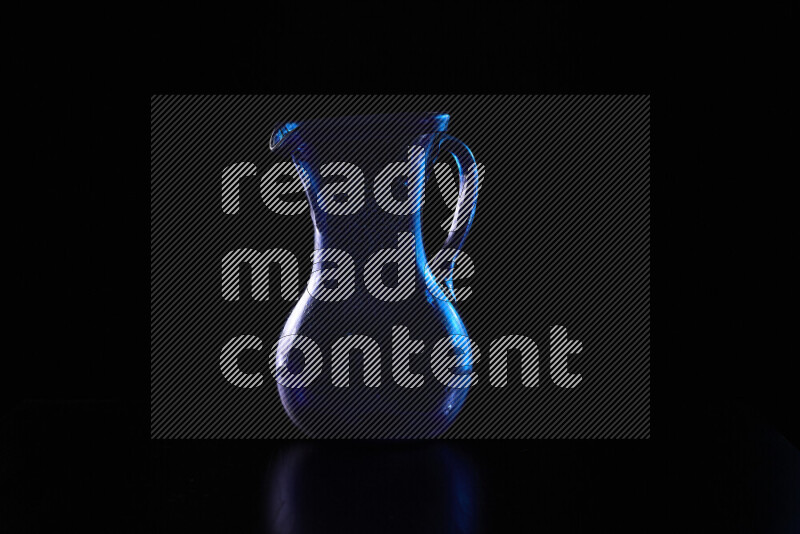 Glassware with rim light in blue and white against black background