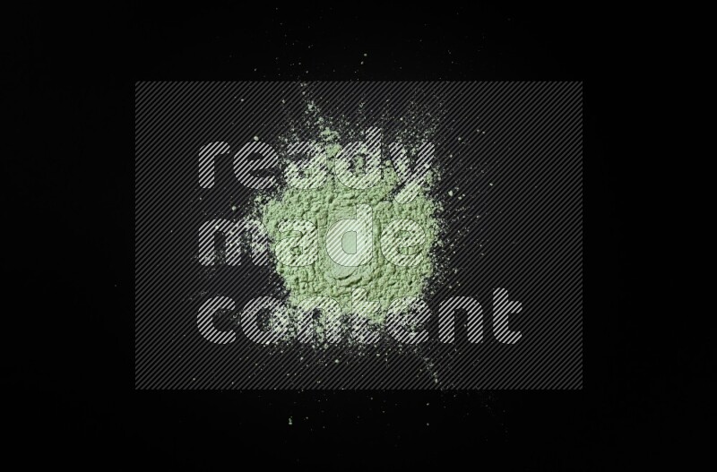 Green powder on black background