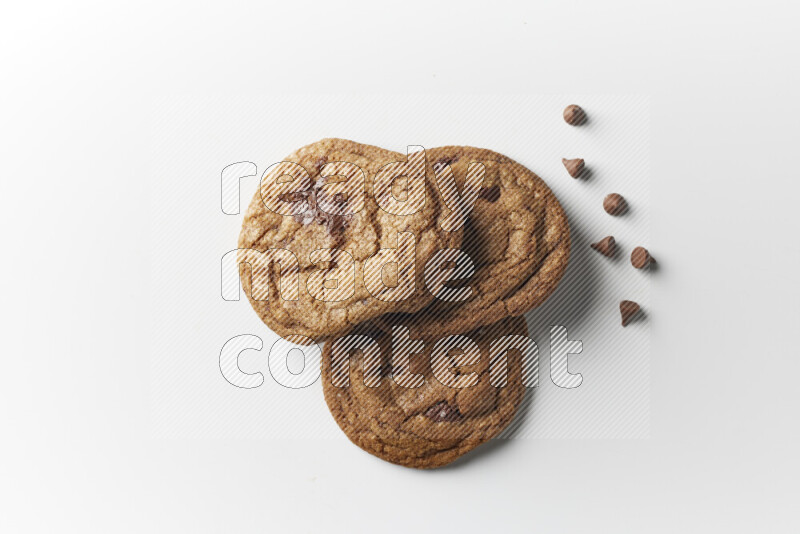 Chocolate chips cookies with chocolate beside it on a white background