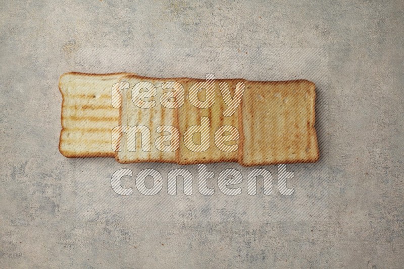 Toasted white Toast slices on a light blue textured background