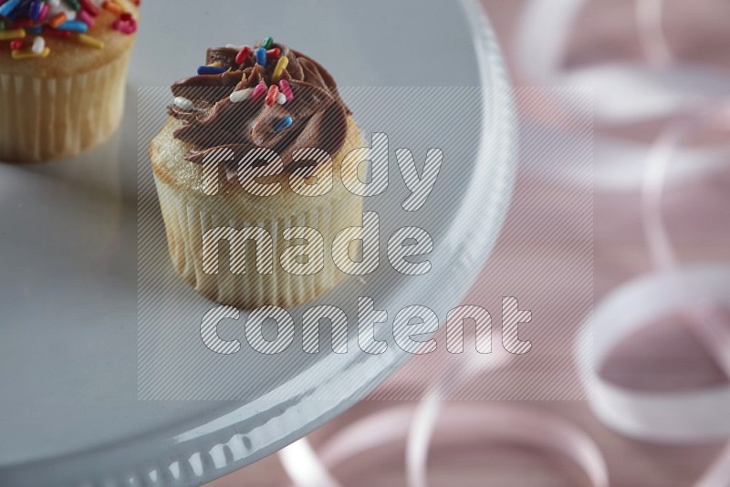 Vanilla mini cupcake topped with chocolate cream