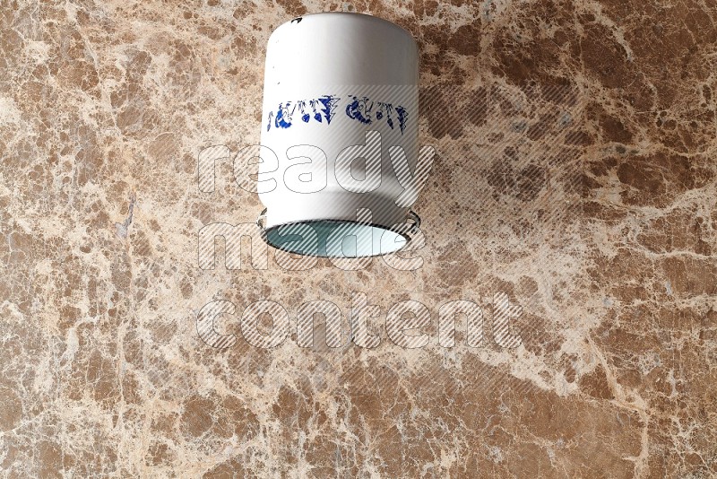Top View Shot Of A Vintage Milk Can On beige Marble Flooring