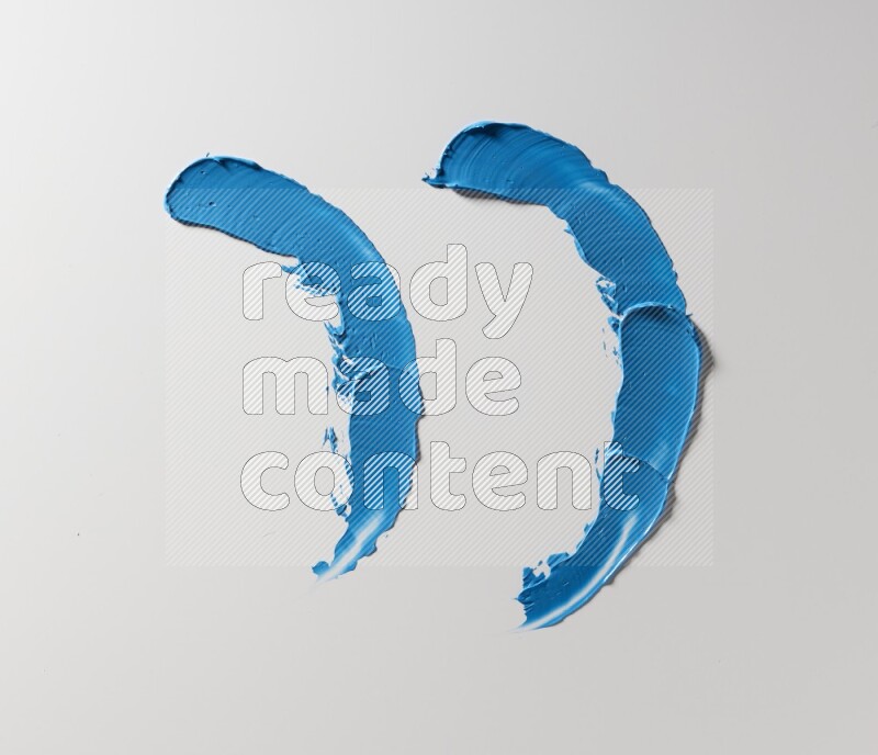 Blue curved painting knife strokes on white background