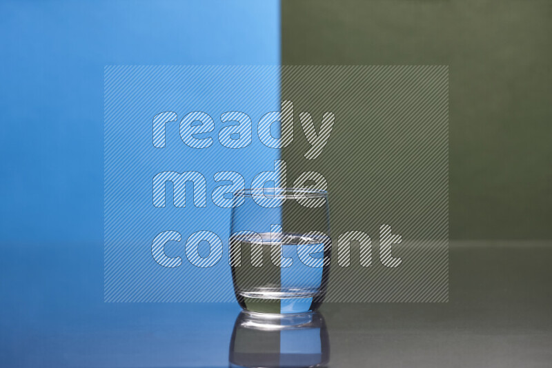 The image features a clear glassware filled with water, set against blue and dark green background