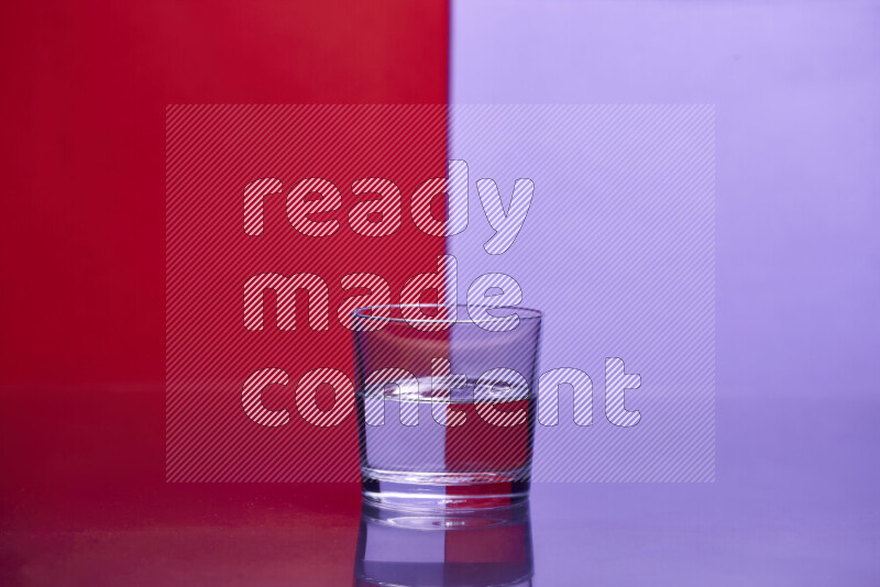 The image features a clear glassware filled with water, set against red and light purple background