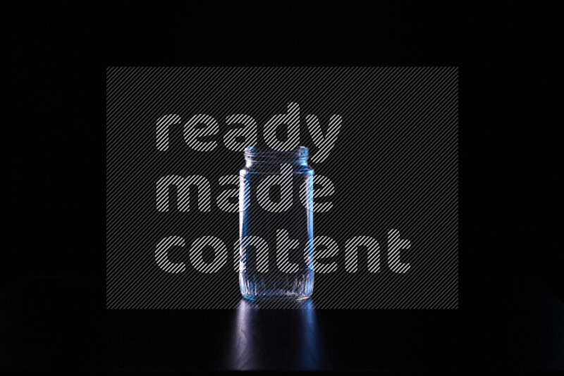 Glassware with rim light in blue and white against black background