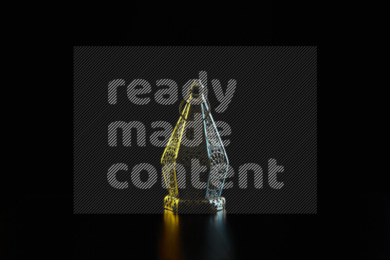 Ramadan lanterns with colored rim light against black background