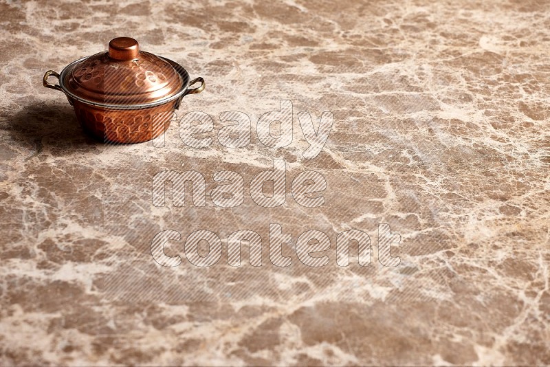 Small Copper Pot on Beige Marble Flooring, 45 degrees