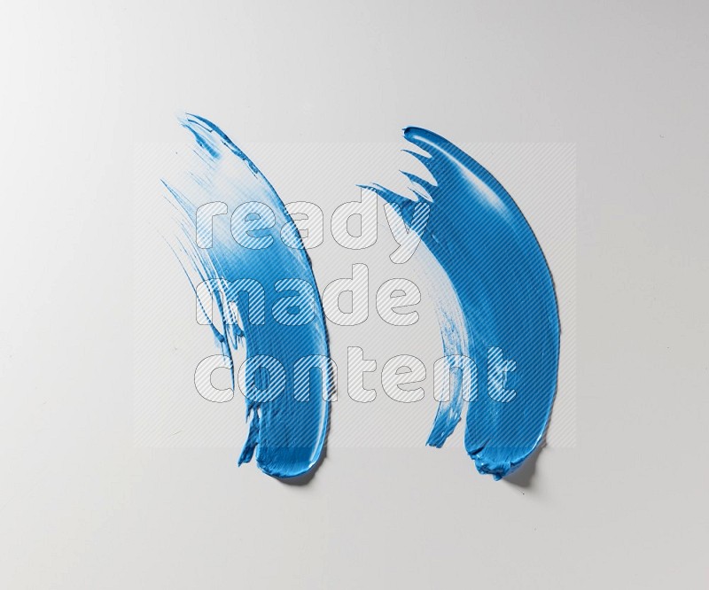 Blue curved painting knife strokes on white background