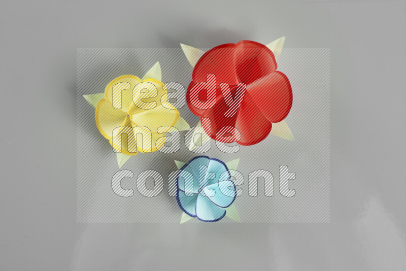 Origami flower on grey background