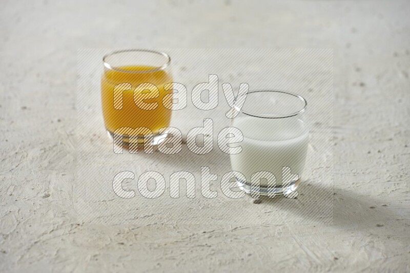 Cold drinks in a glass cup such as water, tamarind, qamar eldin, sobia, milk and hibiscus on textured white background
