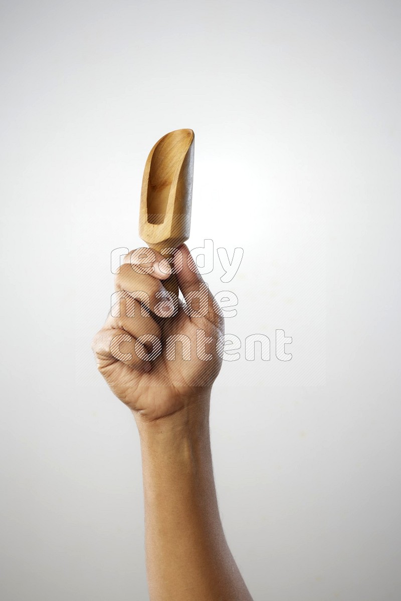 Male Hand Holding Wooden scoop