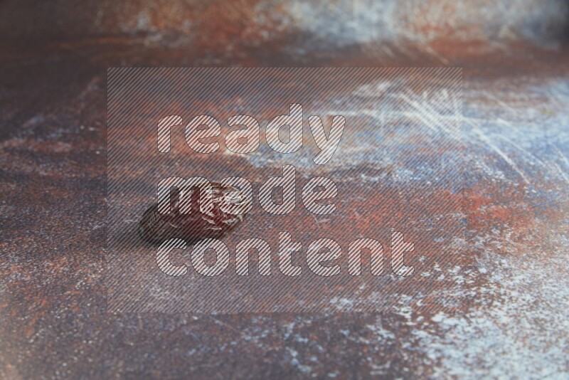 one madjoul date on a rustic reddish background