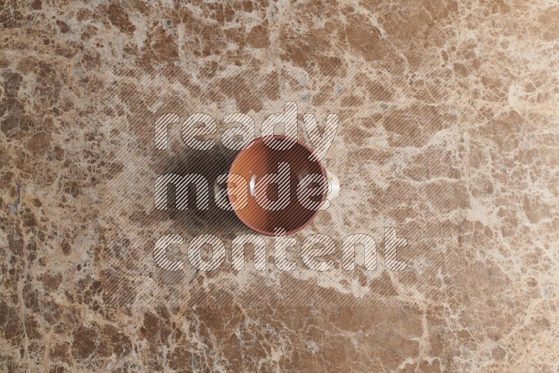 A multicolored pottery pot on beige marble background