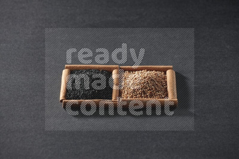 2 squares of cinnamon sticks full of mustard seeds and black seeds on black flooring