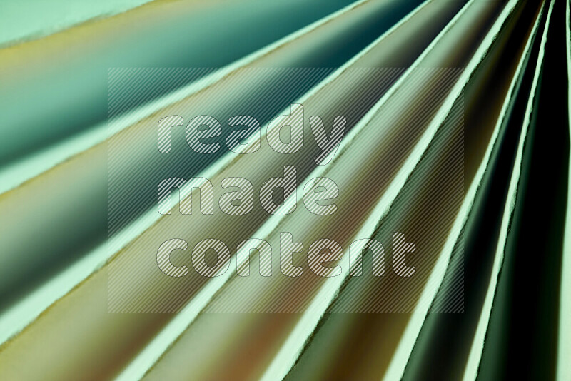 An image presenting an abstract paper pattern of lines in green and gold tones